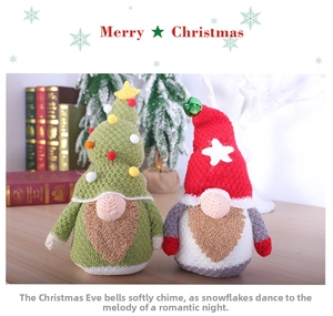 Detail of knitted Christmas gnomes featuring a green tree hat and a classic red hat with stars