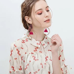Bohemian flamingo dangle earrings with vibrant magenta tassels and metallic hooks