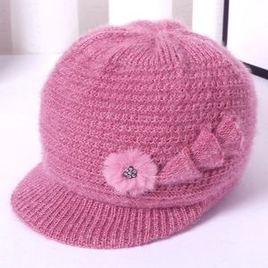 Close-up of pink knit hat for elderly women with plush texture and floral knitted detail