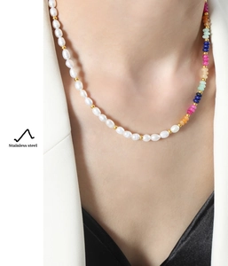 Detail of baroque freshwater pearl and colorful natural stone beaded necklace on model
