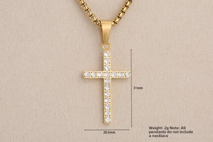 Macro shot of gold-plated cross pendant with micro-pave cubic zirconia stones