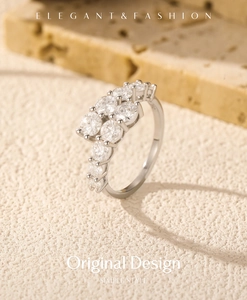 Macro shot of silver ring with VVS1 moissanite stones on a textured stone surface