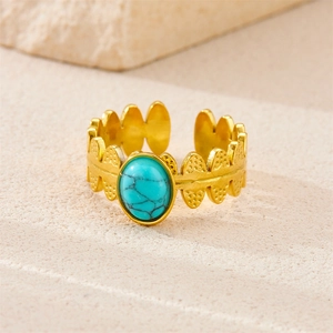 Detail of bohemian gold adjustable ring featuring a vintage oval green turquoise stone