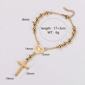 Gold stainless steel rosary bracelet featuring heart icon and cross pendants on white background