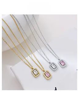 Detail view of square zircon necklaces in gold and silver with sparkling halo setting