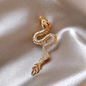 Exquisite gold-plated dragon brooch inlaid with sparkling zircons on elegant silk background