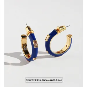 Hand-painted white enamel C-shape hoop earrings with blue zircon in gold finish
