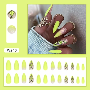 Detail of neon green press on nails set with glitter and black line art on almond tips