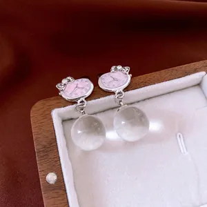 Cat-shaped silver stud earrings with diamond bow and clear round glass ball pendants