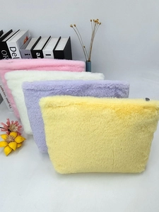 Set of macaron-colored plush cosmetic bags in pink, purple, and yellow soft textures