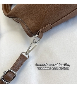 Detailed macro view of silver metallic swivel clasp and lychee pattern leather bag