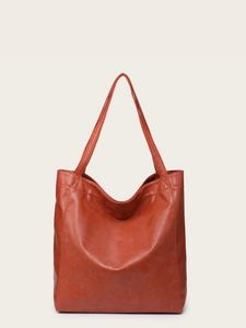 Vue détaillée du grand sac cabas vintage marron rouge en similicuir souple