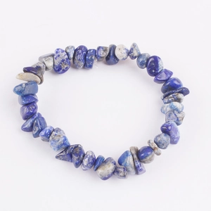 Macro shot of colorful natural stone beads showing blue lapis lazuli textures on white background