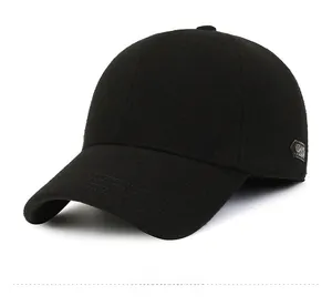 Detail view of the black wool baseball cap showing thick texture and metal side emblem