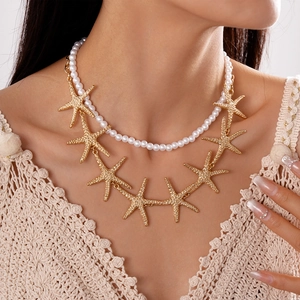 Detailed close-up of double-layer beaded necklace with gold starfish and white pearls