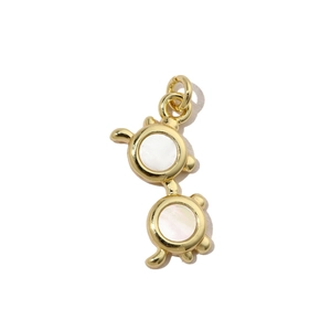 Detailed macro view of gold-framed pendant with white mother of pearl inlay charms