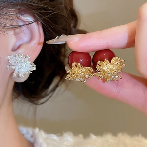 Detailed view of fireworks pearl stud earrings with rhinestone inlay in multiple colors