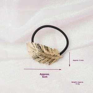 Detail of gold leaf hair tie showing dimensions of 6cm x 3.5cm and 14.5g weight