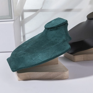 Detail of dark green velvet necklace display stand with premium solid wood base
