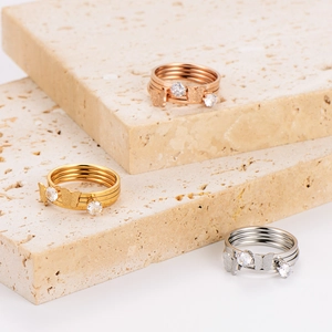 Three-color multilayer stainless steel butterfly rings with crystals on travertine display