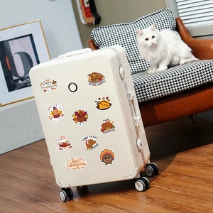 100 piece pack of waterproof Thanksgiving turkey stickers on a white suitcase