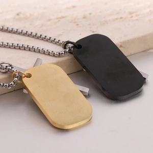 Macro shot of 44mm gold and black military dog tag pendants on stainless steel chains
