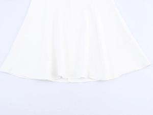 Detailed view of the smooth white satin fabric and flowing fishtail hemline on a dress