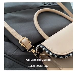 Detail showing the adjustable metal buckle and silver bead trim on a beige handbag