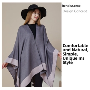 Detail of dark grey knit shawl with light grey contrast trim and textured fabric