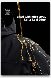 Close-up of waterproof black hooded jacket fabric with liquid beads showing stain resistance