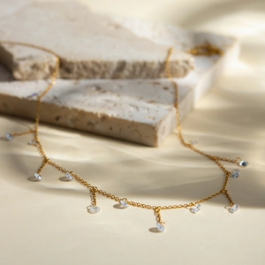 Detailed view of 18k gold plated stainless steel necklace with sparkling clear zircon charms