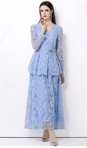 Detail of light blue lace maxi dress with buttons, long sleeves and floral embroidery