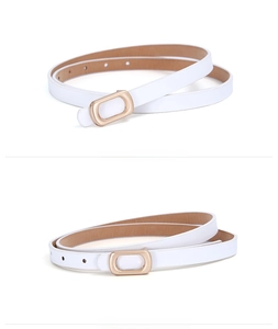 Close-up of white skinny PU leather belt with golden oval buckle and adjustment holes