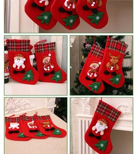 Detail of Christmas stockings with Santa and snowman figures hanging on a fireplace