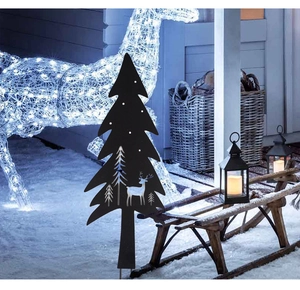 Detail of black metal Christmas tree stake with deer silhouettes for garden lawn decoration