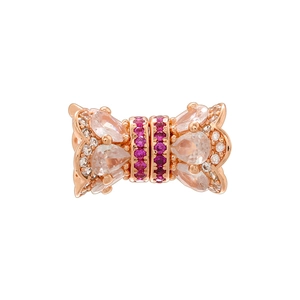 Macro detail of rose gold bow bead with sparkling cubic zirconia and ruby gemstones