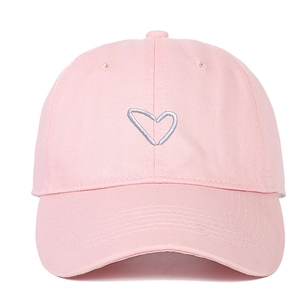Pale pink cotton baseball cap featuring a white embroidered heart on the front