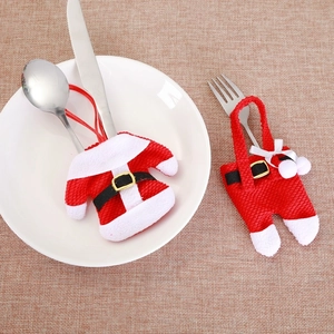 Christmas silverware holder set with Santa clothes and pants design on table