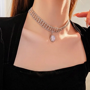 Elegant multi-layer rhinestone choker with teardrop zircon pendant on a model