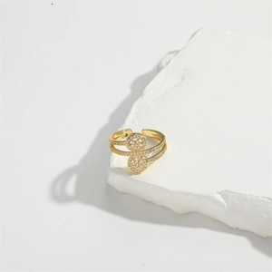 Detail showing an adjustable gold open ring with dual overlapping diamond-encrusted circles