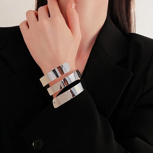Modern silver multi-layer spiral cuff bracelet with polished finish on model wrist