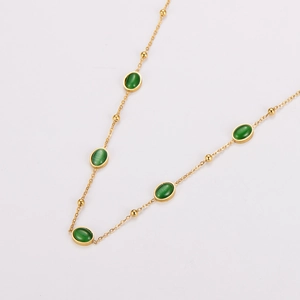 Vintage oval green gemstone necklace with gold chain and stainless steel accents