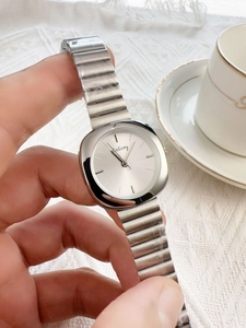 Elegant silver square quartz watch with metal stretch band worn on a wrist