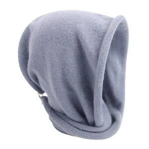 Detail of soft grey-blue knitted fabric texture on winter scarf beanie hood accessory