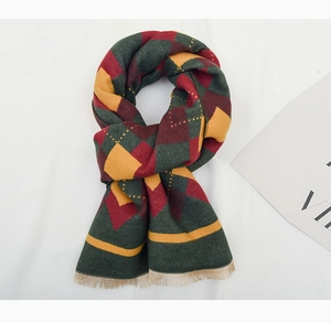 Detailed view of kids' winter argyle scarf with red and green plaid and fringe