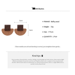 Detail view of geometric earrings with square wood studs and woven raffia semicircles