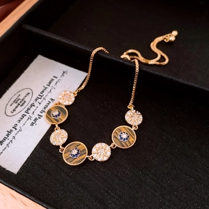 Detailed close-up of 18k gold plated bracelet with tiger eye stones and zircon accents