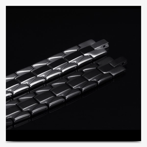 Detail of silver and black stainless steel geometric link bracelets with elegant reflections