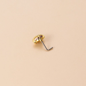 L-shaped gold nose stud with a purple flower-shaped cubic zirconia crystal