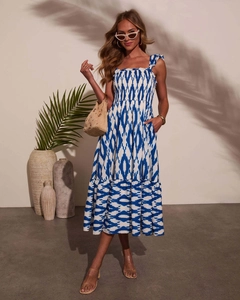 Detail of smocked bodice and ruffled straps on a blue floral summer midi dress